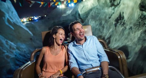 Guests enjoy a nighttime roller coaster ride through mountain peaks during Disney After Hours at Walt Disney World Resort.