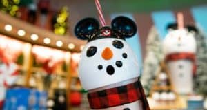 Festive Mickey Mouse snowman cup with striped straw and red plaid scarf at World of Disney—holiday must-have for park fans!.