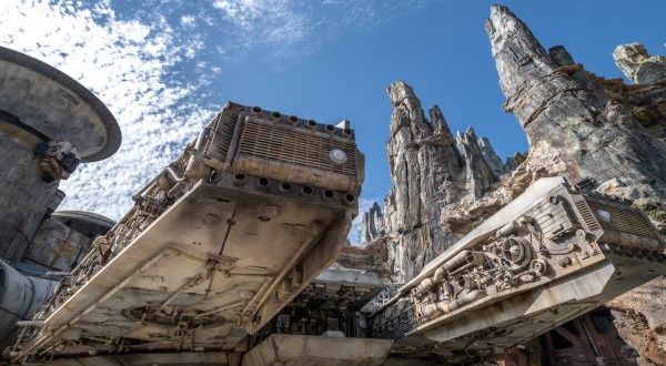 A rugged Star Wars spaceship lands amid craggy peaks, evoking the adventure of Disney’s Galaxy’s Edge at a Disney park.