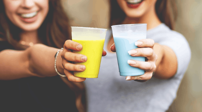 Guests toast with vibrant blue and yellow drinks, celebrating the flavors of Star Wars: Galaxy’s Edge at Disneyland.