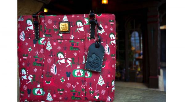 Festive Dooney & Bourke tote with rocking horses, trees, ornaments, and a Mickey Mouse tag—ideal for Disney Parks visitors.
