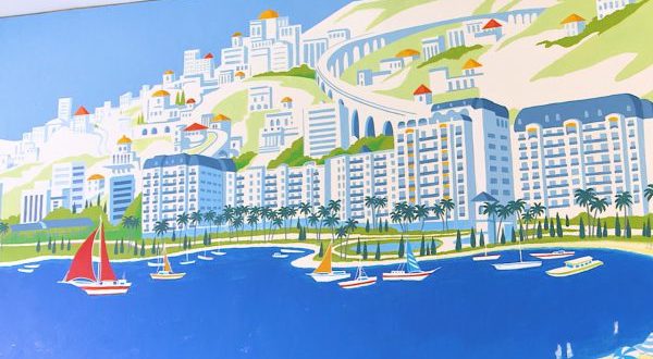 Vibrant mural of a Disney Riviera-inspired Mediterranean city with hills, towers, palms, and sailboats on sparkling blue water.