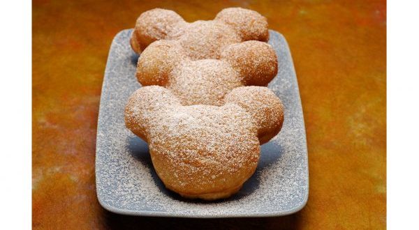 Classic Mickey Mouse-shaped beignets dusted with powdered sugar, served at Scat Cat Club—a must-try for Disney Annual Passholders.