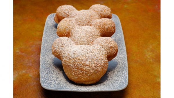 Classic Mickey Mouse-shaped beignets dusted with powdered sugar, served at Scat Cat Club—a must-try for Disney Annual Passholders.