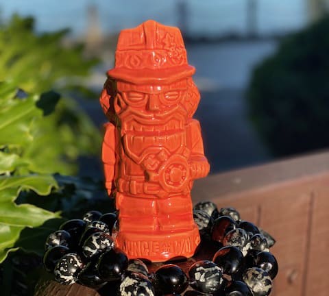 A firefighter-themed orange tiki mug with a beard, plus black-and-white beads—spotted at Disney Parks’ Best Bites in Dec 2019.