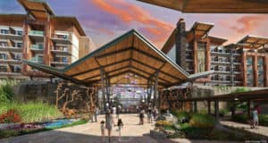 Guests stroll toward the grand entrance of Reflections – A Disney Lakeside Lodge at Walt Disney World during a vibrant sunset.