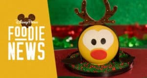 A reindeer dessert with red and green sprinkles at Disney Springs, next to a “Foodie News” sign, Dec 2019.