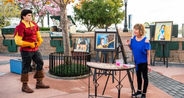 At Epcot's Festival of the Arts, an artist paints Disney characters while Gaston from Beauty & The Beast looks on nearby.