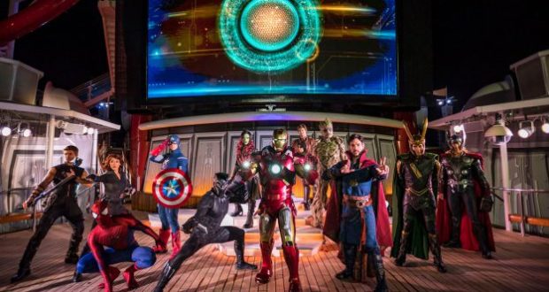 Avengers assemble on the Disney Cruise Line ship deck at night, illuminated by a glowing screen during Marvel Day at Sea.