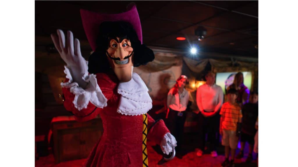Captain Hook greets fans with a wave as guests look on, capturing the magic of Walt Disney World indoors.