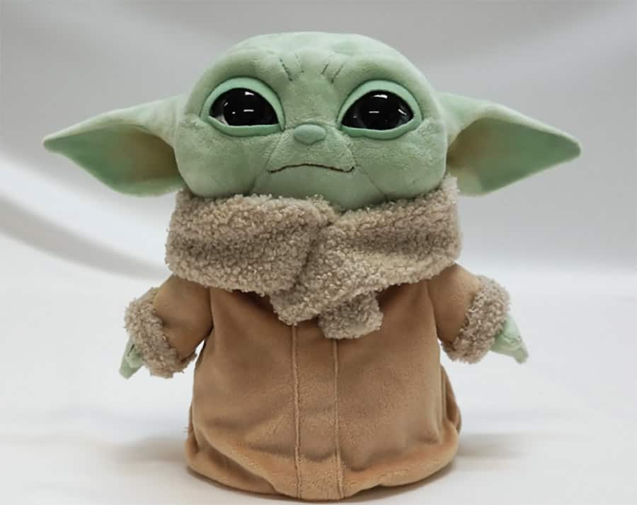 Grogu plush toy from Star Wars: The Mandalorian, with big eyes and brown robe, available at Star Wars: Galaxy's Edge.