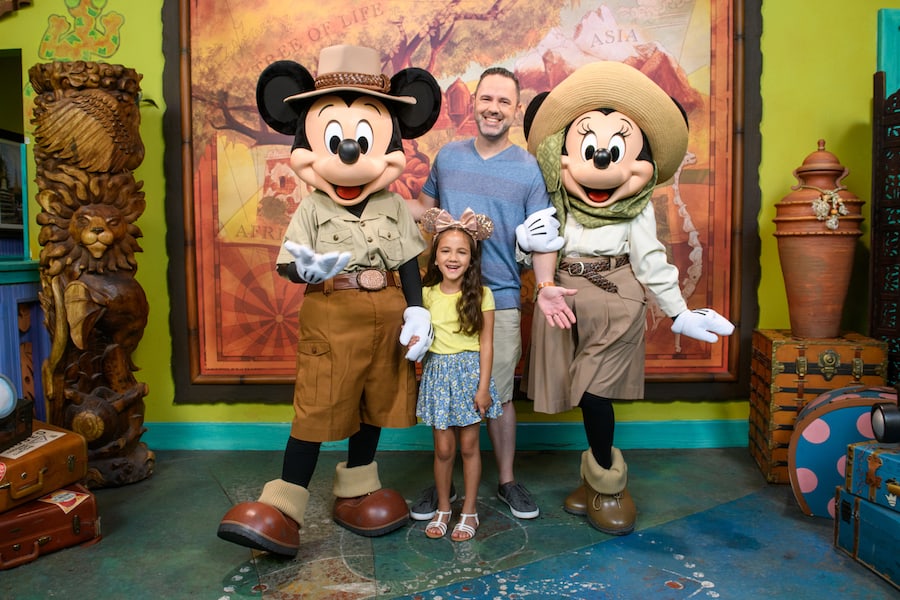Guests join Mickey and Minnie Mouse in safari gear for a magical PhotoPass moment at Disney World's adventure-themed area.