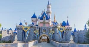 Sleeping Beauty Castle at Disneyland Park, blue rooftops gleaming under clear skies—a must-see icon for Disney fans and park lovers.