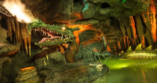 The iconic dragon statue lurking in its dark cavern beneath Disneyland Paris' Sleeping Beauty Castle, inspired by La Tanière du Dragon.