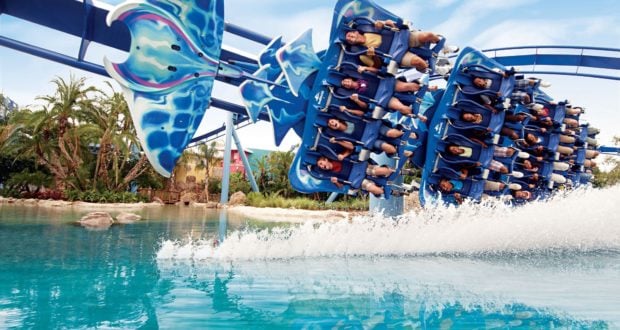 SeaWorld thrills return as Kraken soars above sparkling water, sending up a splash amid palm trees and blue skies on June 11 reopening.