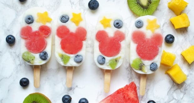 Mickey Mouse-shaped fruit pops shine with Disney magic—colorful stars, blueberries, and kiwi on marble, made with just 2 ingredients.