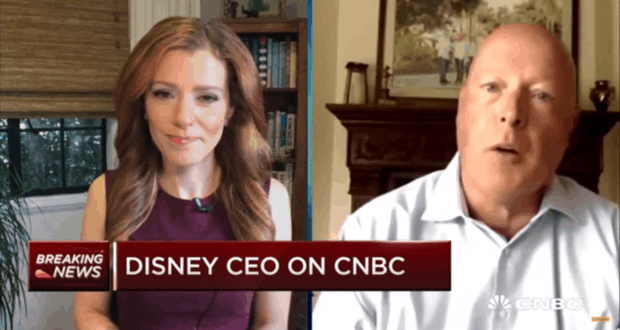 Two people video chatting; CNBC banner says "Disney CEO interview" with "Breaking News" about changes to the Disney parks experience.