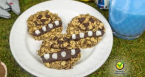 Chewbacca oatmeal cookies await on a Star Wars-themed plate beside a glass of iconic Blue Milk at Galaxy’s Edge.