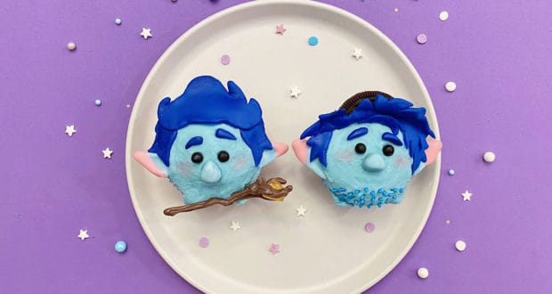 Ian and Barley character cupcakes from Pixar’s Onward on a white plate with festive sprinkles, set against a purple backdrop.