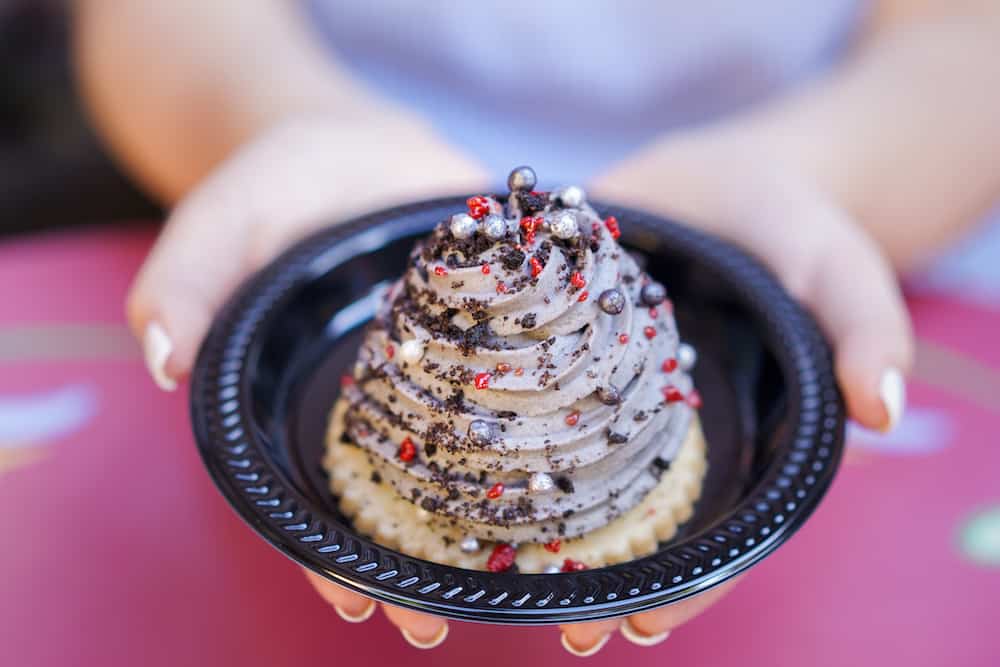 Indulge in the iconic Grey Stuff at Disney Parks—a swirled gray treat with sprinkles and red crumbs, straight from the movies!.