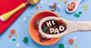 A Goofy Movie-inspired "HI DAD" cookie sits atop ice cream, surrounded by candy and sprinkles at Disneyland Resort.
