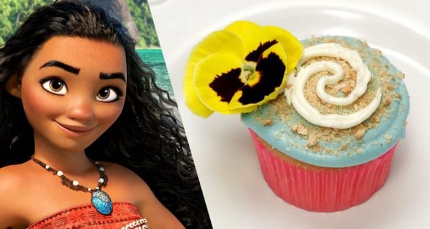 Moana in a tropical setting next to themed cupcakes with ocean-blue swirled icing and a yellow flower, perfect for Disney fans.