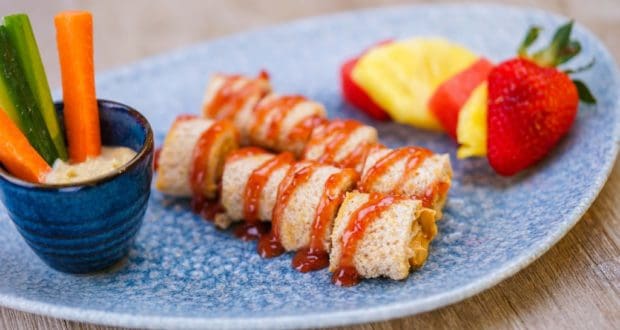 PB & J Rolls from Lamplight Lounge served with veggie sticks, dip, pineapple, and a strawberry—a Disney California Adventure treat.