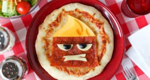 Anger Pizza with extra cheese and pepperoni forms a cartoon scowl on a red plate—an animated snack worthy of Toon Town!.