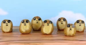Six Star Wars Porg-inspired potatoes with seaweed faces resemble surprised creatures, perfect for fans at Galaxy’s Edge.