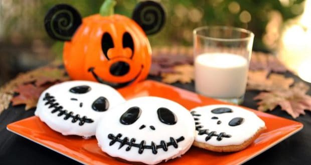 Jack Skellington cookies on an orange plate with milk and a pumpkin jar—ideal for Disney Halloween fans or Halfway2Halloween.