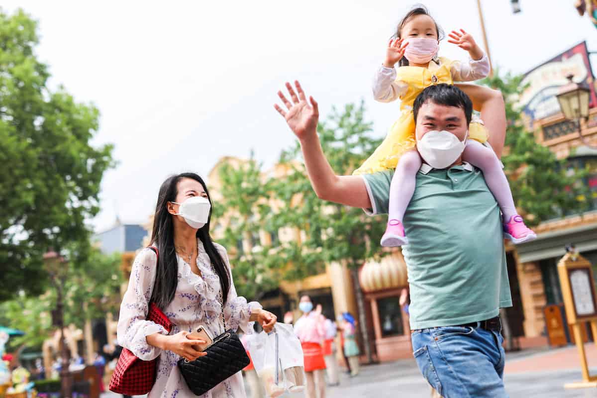 a family walking in shanghai disneyland