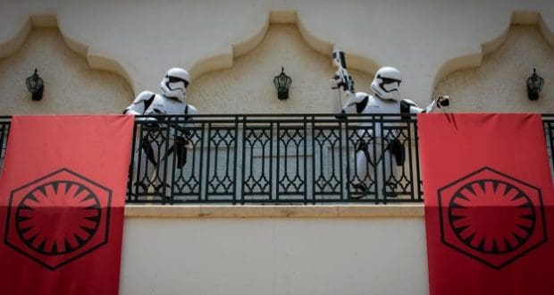 Stormtroopers patrol a Disney Springs balcony as bold First Order banners drape above the crowd, adding galactic flair.