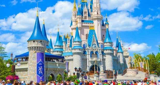 Guests fill Main Street in front of Cinderella Castle at Disney World on a sunny day as the Orange County Mayor urges mask-wearing.