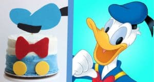 A Donald Duck-themed cake on display next to Donald in his iconic blue sailor suit, reminiscent of a Disney park celebration.
