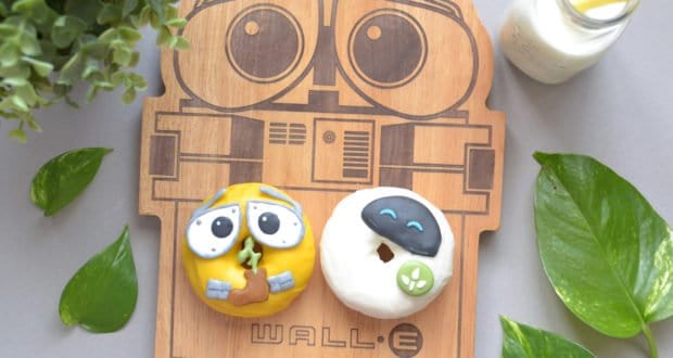 WALL•E and Eve donuts on a themed board, with milk and greenery—Pixar-inspired snacks for your next Disney movie night.