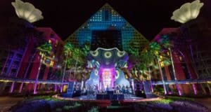 Vibrant stage with live music shines before the Swan & Dolphin hotel at night during the Swan & Dolphin Food & Wine Classic.