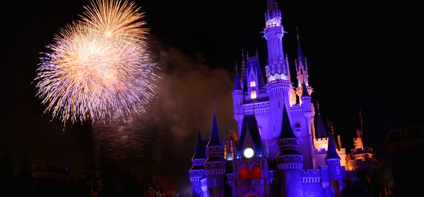 Cinderella Castle in Tokyo Disney Resort aglow at night, as vibrant fireworks light up the sky for an unforgettable Disney evening.