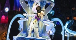 Mickey Mouse dazzles in a sparkly outfit atop a glowing float, with fireworks lighting up the castle at Tokyo Disney Resort’s parade.