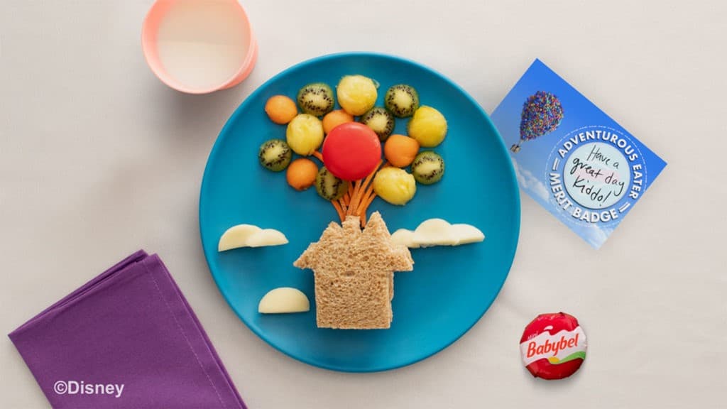 Up Up And Away Sandwich on a plate, featuring cheese clouds and fruit balloons, styled after Disney Pixar’s “Up.”.