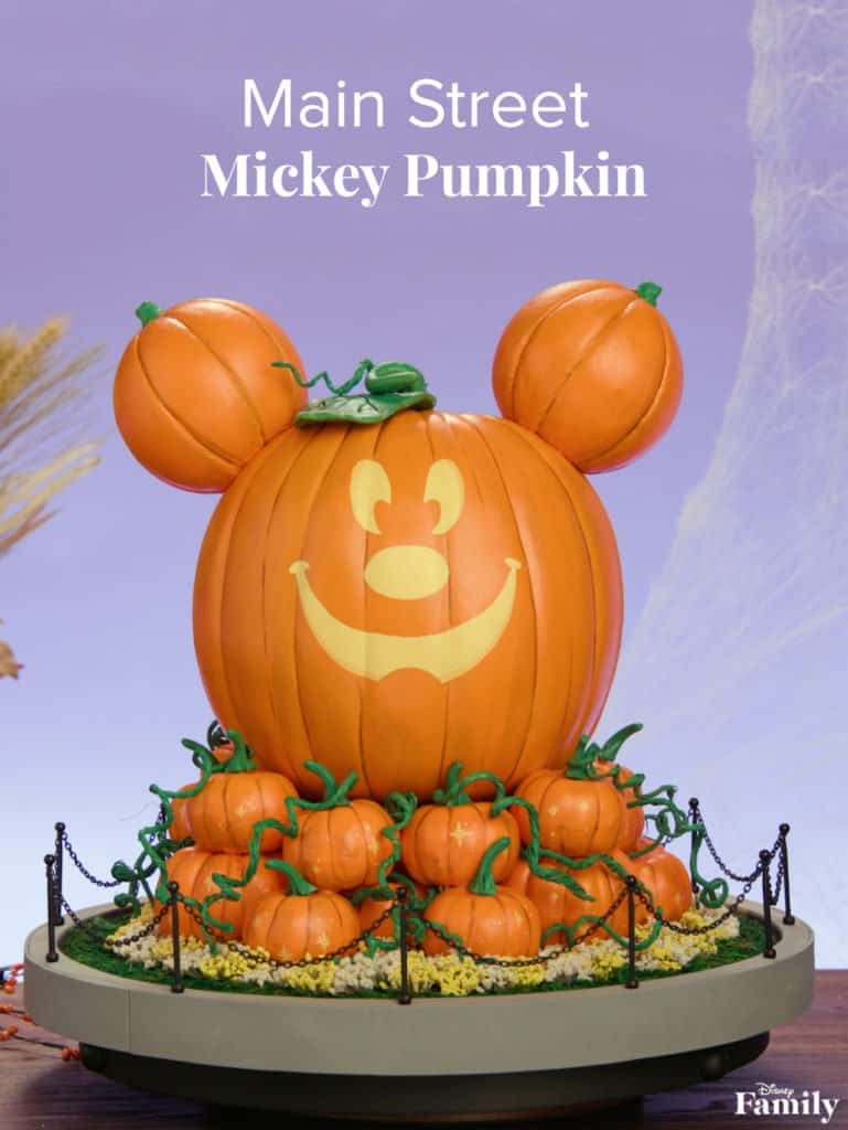 The iconic Mickey Pumpkin shines on Main Street, surrounded by festive pumpkins, creating Halloween magic at Disneyland.