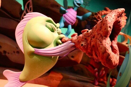 Under the Sea - Journey of the Little Mermaid, a fish blows a rocky horn