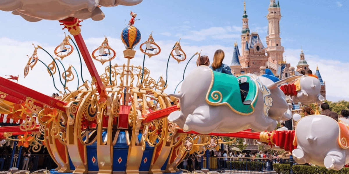 a mother and her child riding dumbo in shanghai disneyland