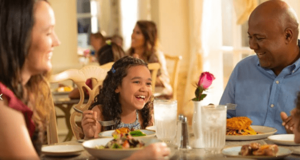 Family Sitting Down to a Table Service Meal