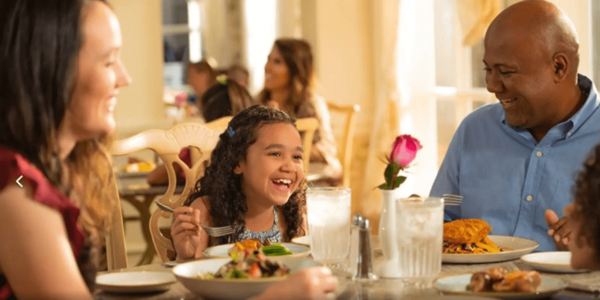 Family Sitting Down to a Table Service Meal