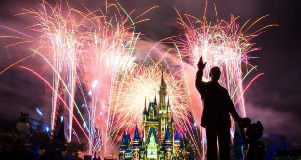 Fireworks at Cinderella Castle with Walt Disney Statute