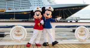 Mickey and Minnie in front of a Disney Cruise Line ship