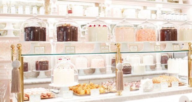 A display of baked goods on a white counter at The Cake Bake Shop