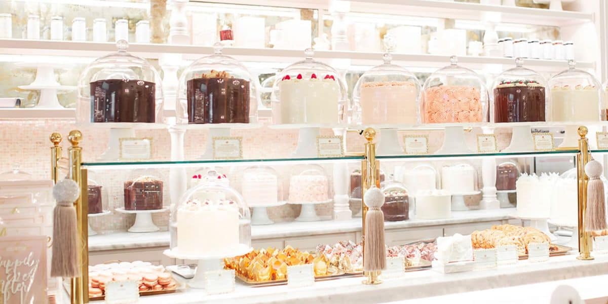 A display of baked goods on a white counter at The Cake Bake Shop