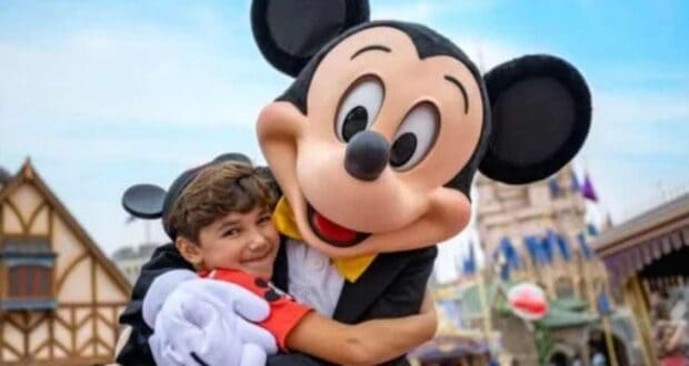 Mickey and a child hugging
