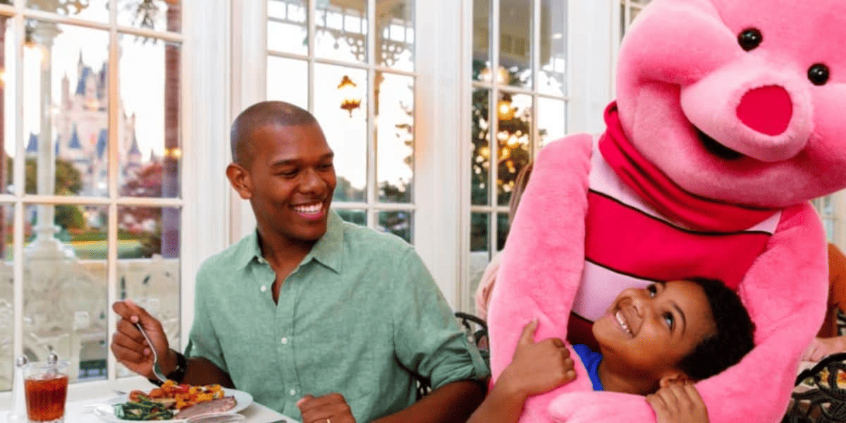 Happy father and son with pink pig stuff toy